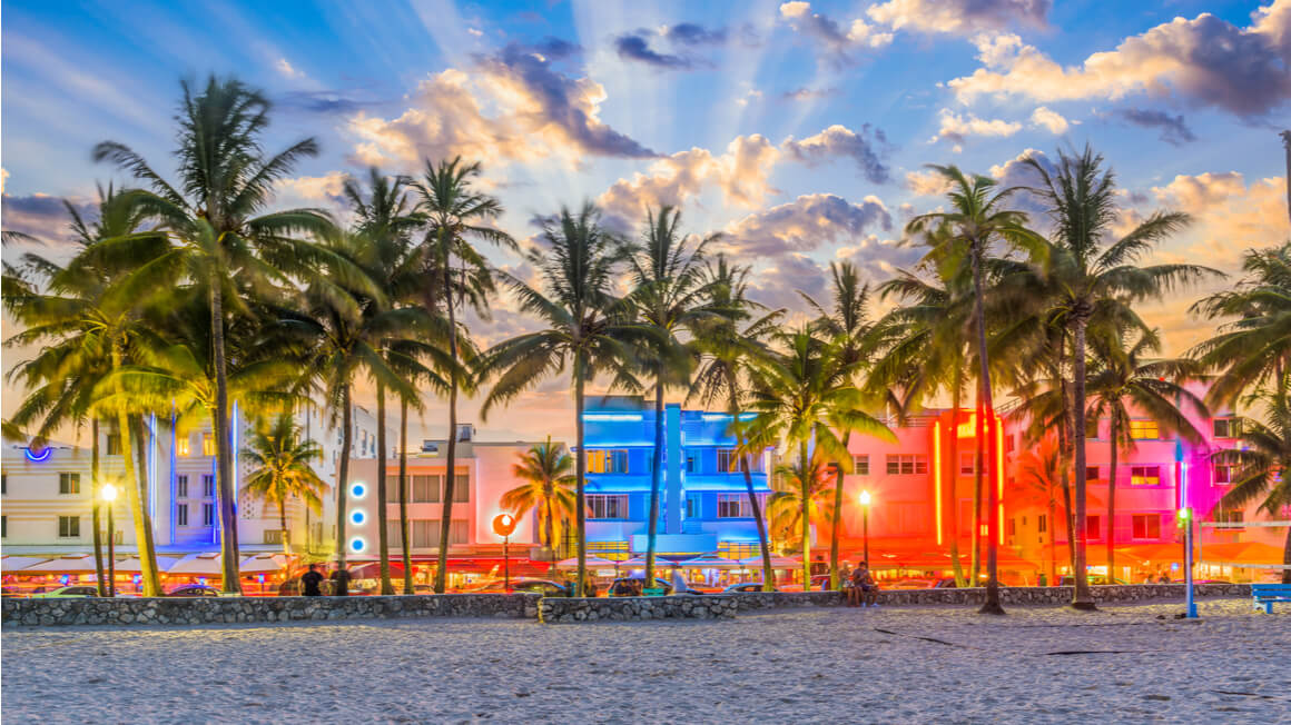 colorful miami beach sunset looking at ocean drive from the sand
