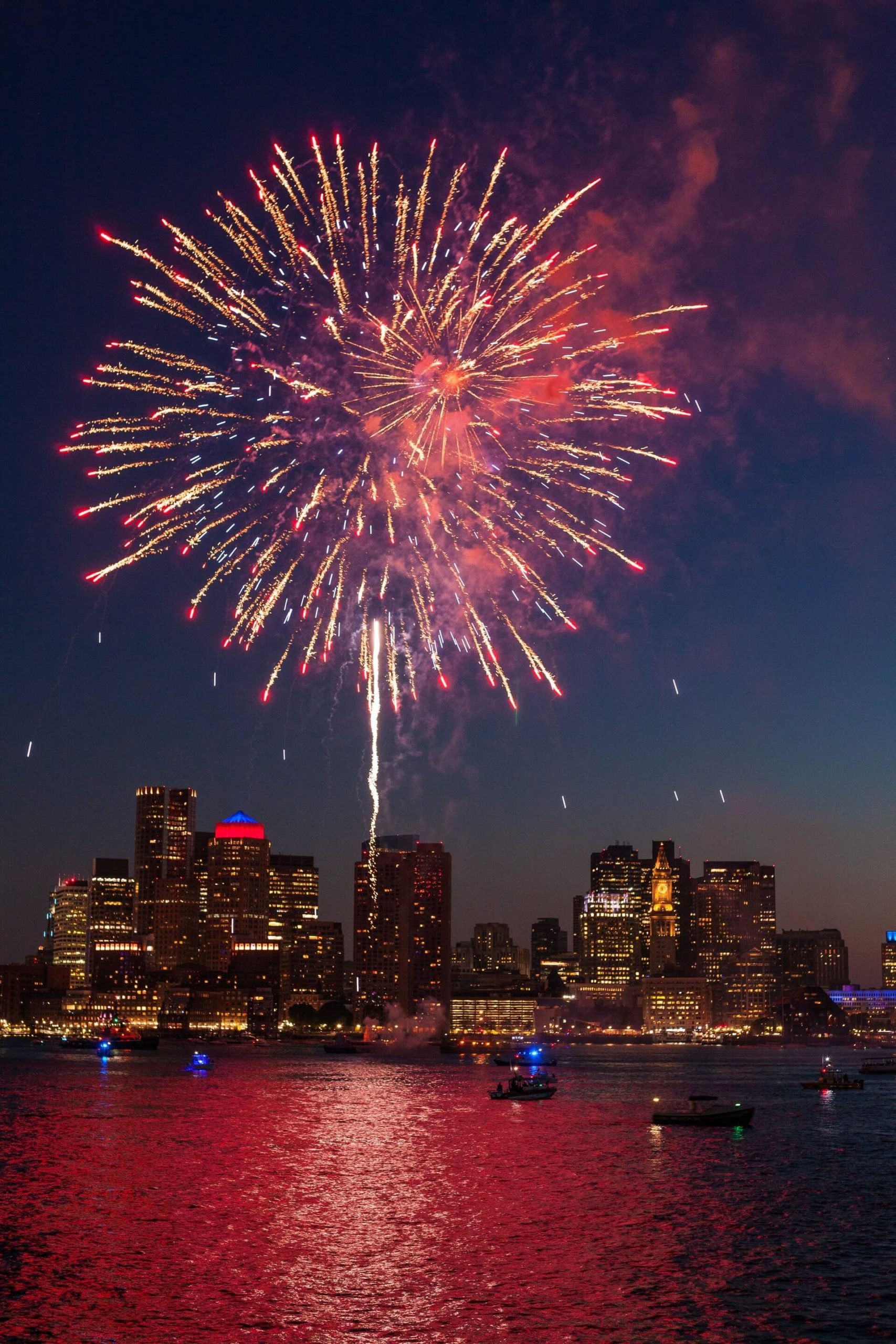 boats in water and fireworks in sky boston travel guide