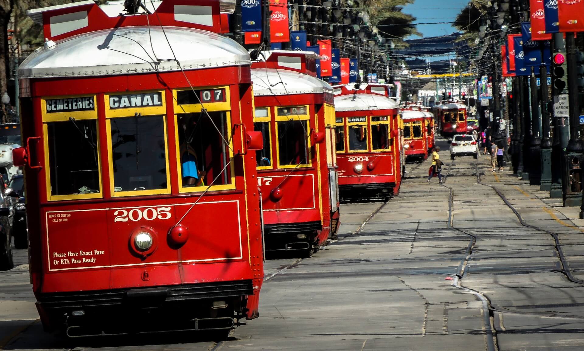red cable cars on canal street in new orleans