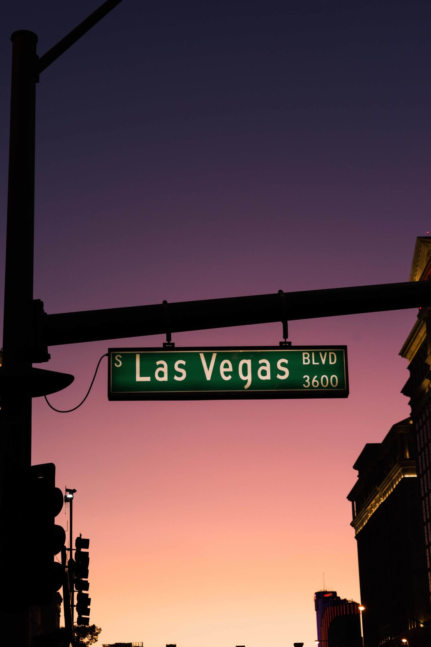 las vegas boulevard sign during a purple and pink sunset