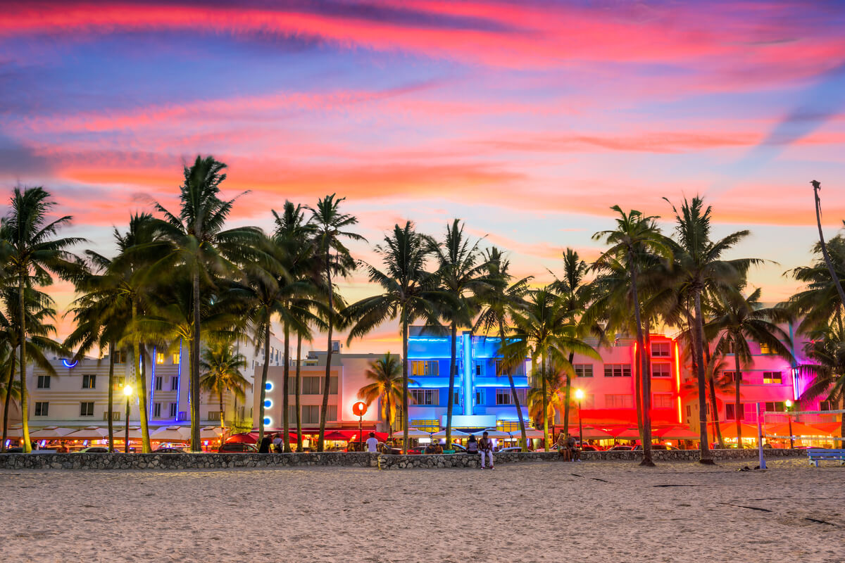 sunset on miami beach bright pink streaks in a blue sky