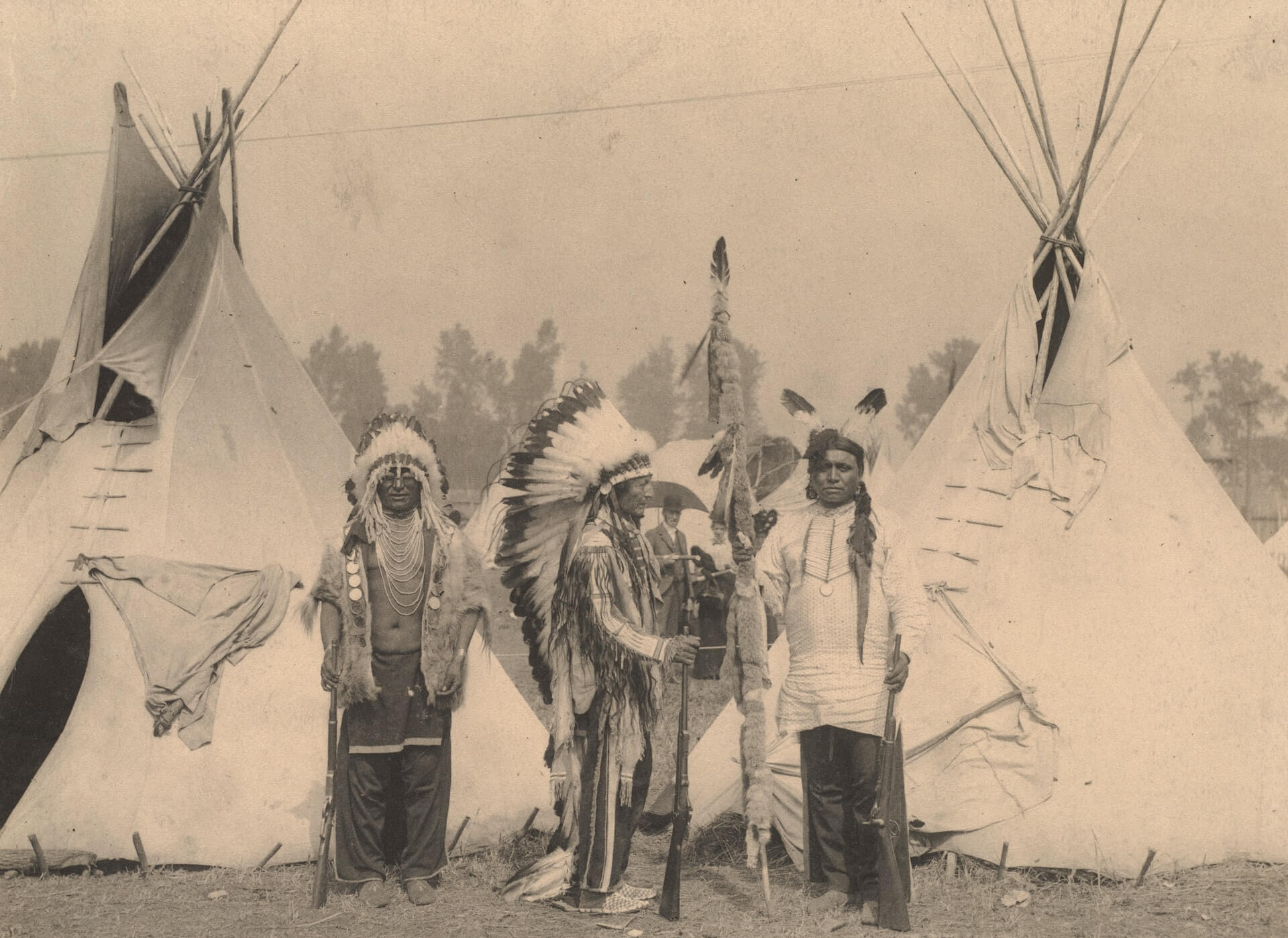 native americans in their traditional dress posing for an old photo