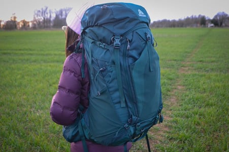 A girl posing with the Gregory Deva 70 Backpack 