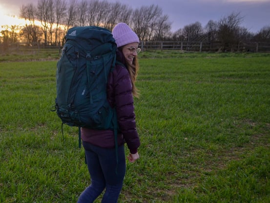 Woman wearing Gregory Deva 60 Backpack in field