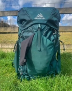 Front view of the Gregory Deva 60 with jacket in front pocket