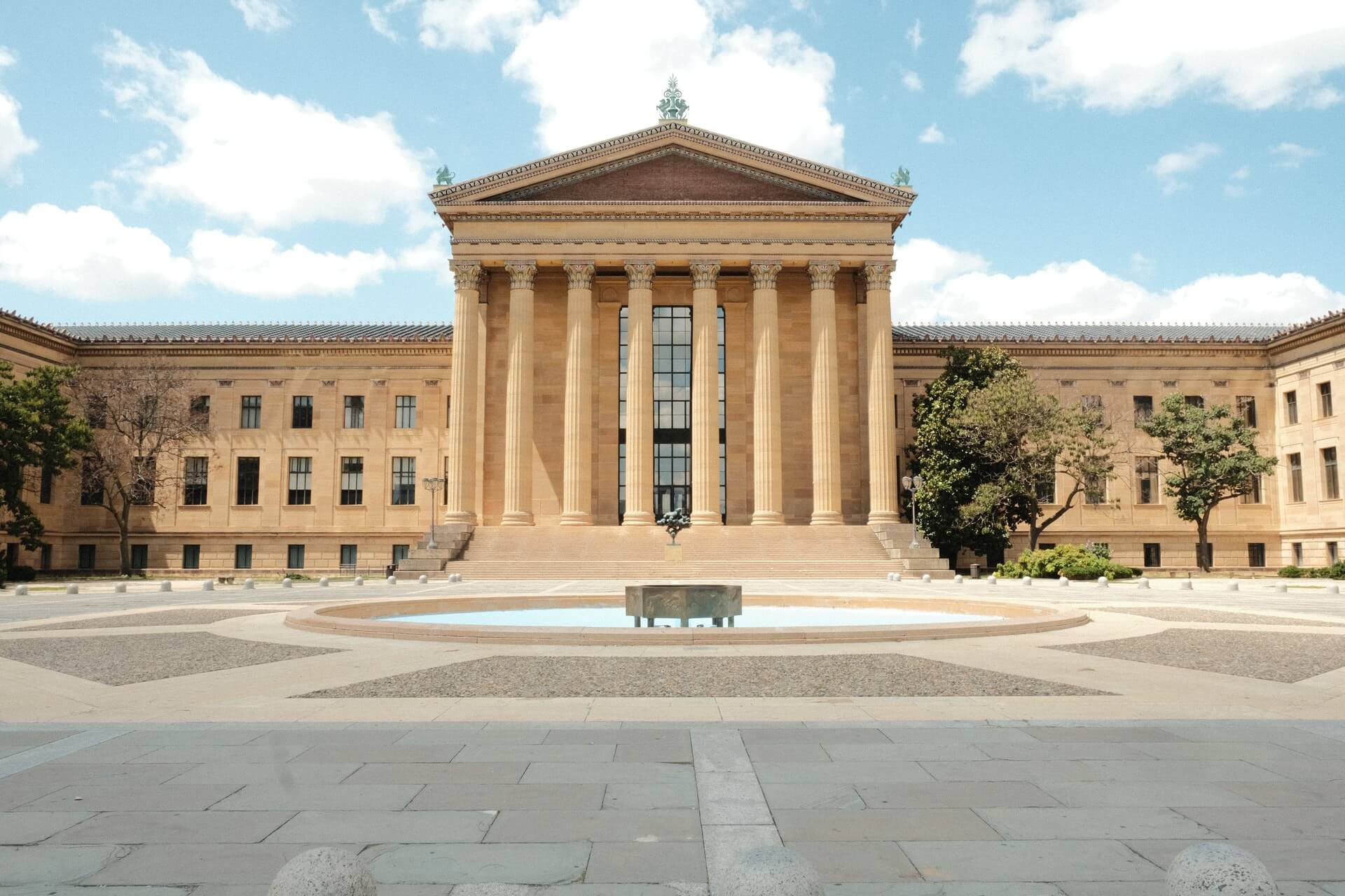 old off-white colored philly museum of art on a blue sky day