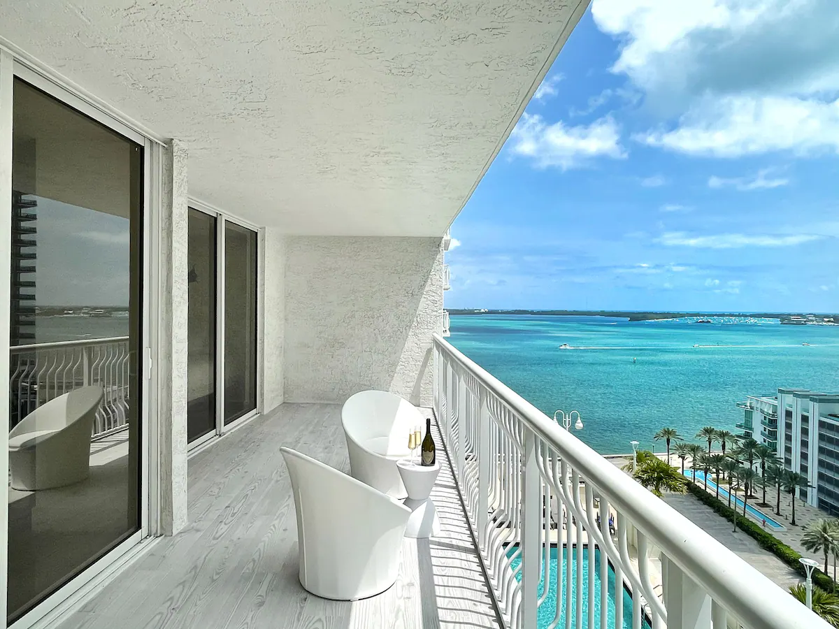 white balcony with an ocean and pool view in miami