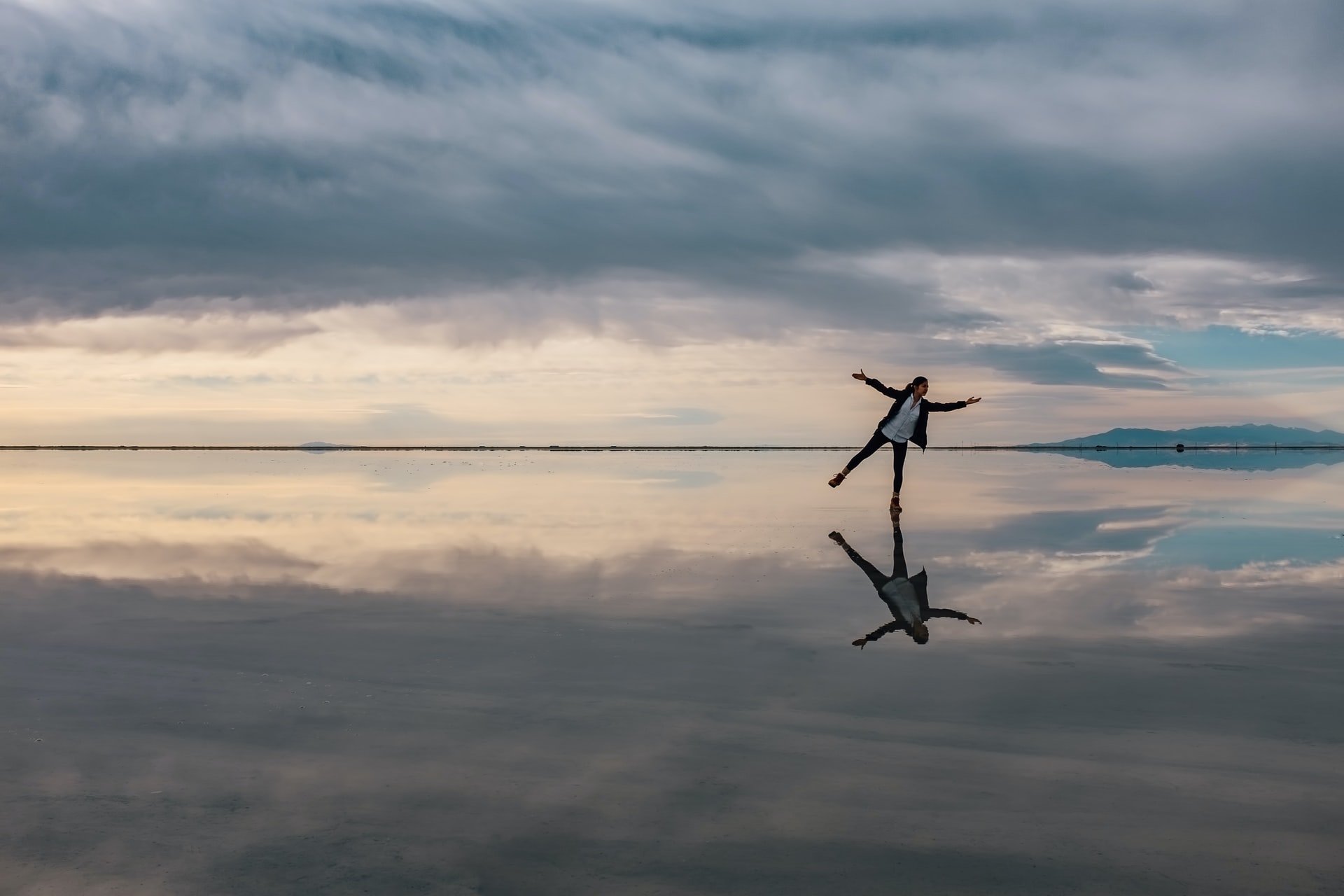 girl standing on salt flats at sunset in utah