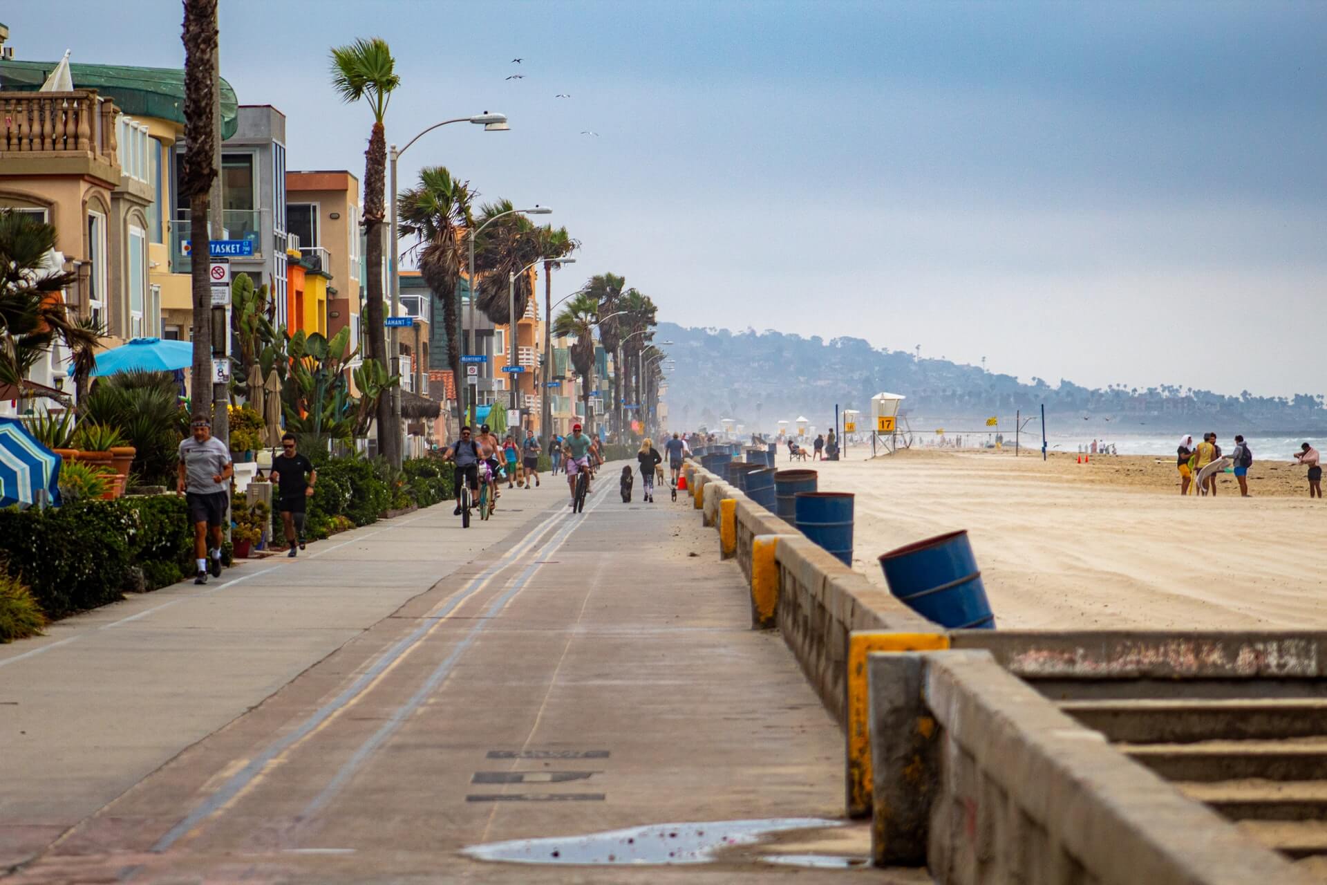 san diego boardwalk black pavement on left side and beach on right