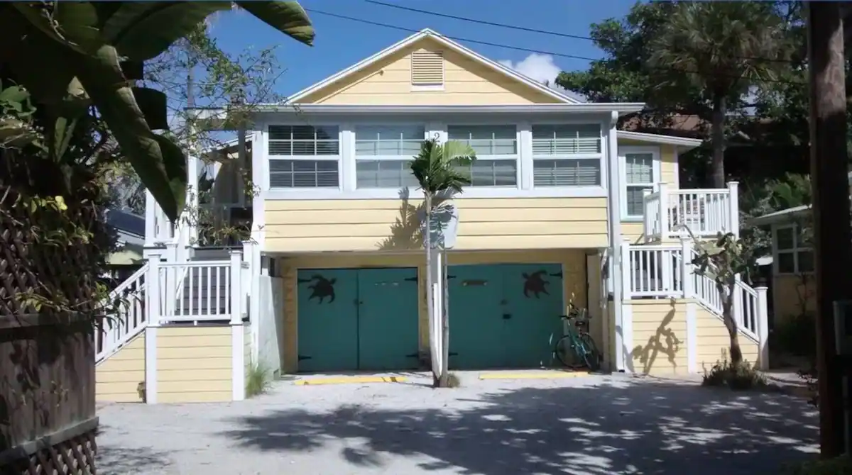 yellow beach cottage with palm trees in florida east coast roadtrip