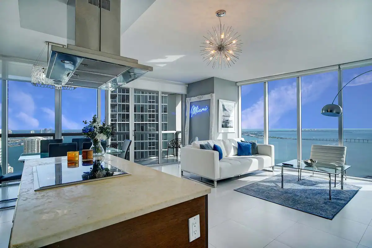 one of the best airbnbs in miami: living room with floor to ceiling window and a water view