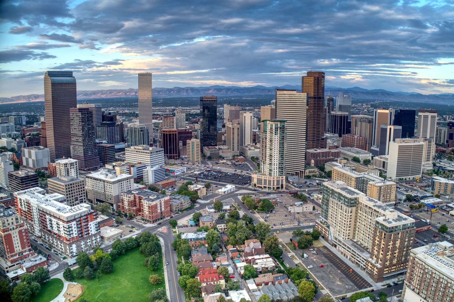 view of downtown denver with mountains in background denver travel guide 