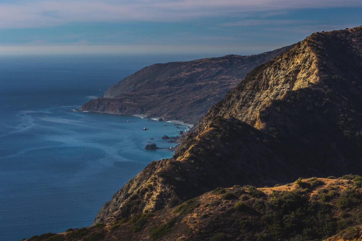 rugged tan and green mountains and a blue ocean underneath of catalina island trail near los angeles