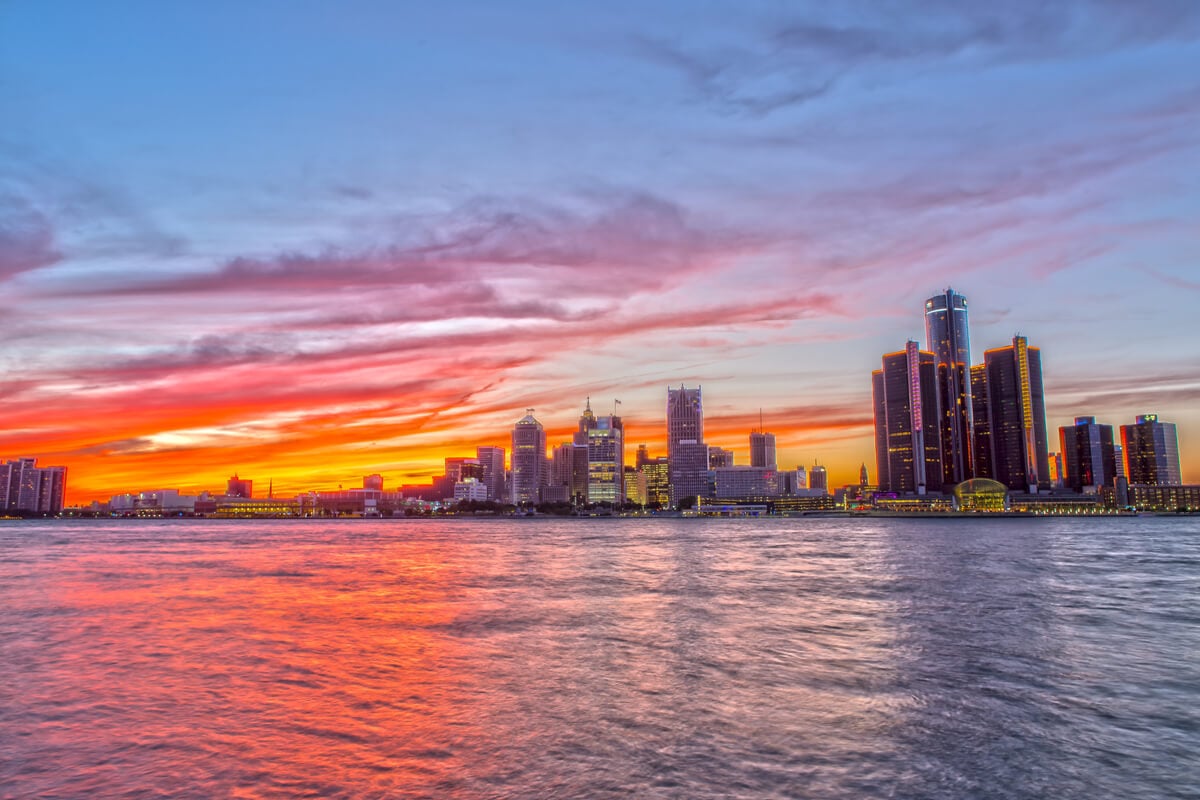 View across the water, toward Detroits city skyline at sunset, USA