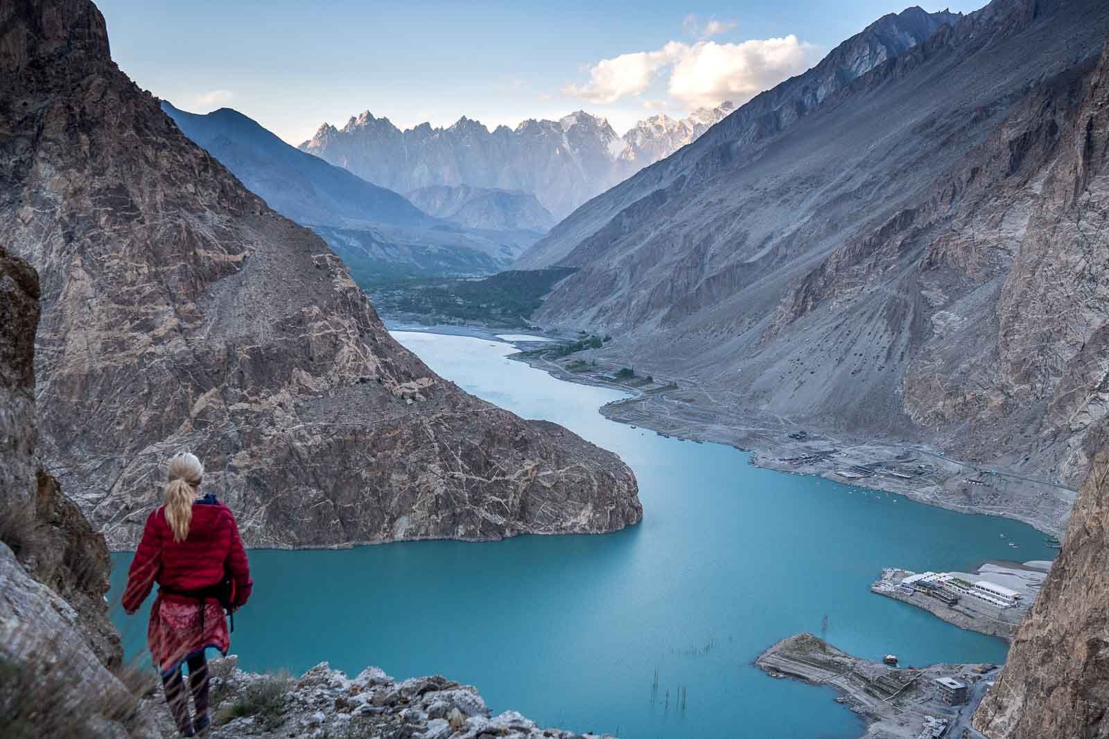 girl walking down cliff in northern pakistan