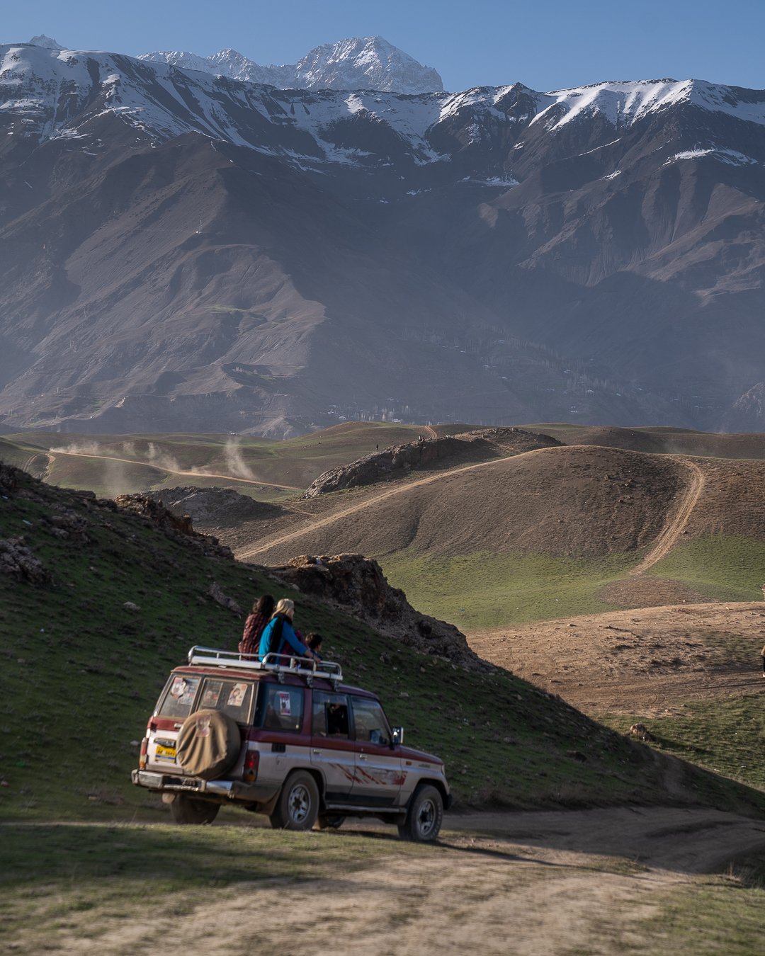 girls riding on top of a truck backpacking pakistan