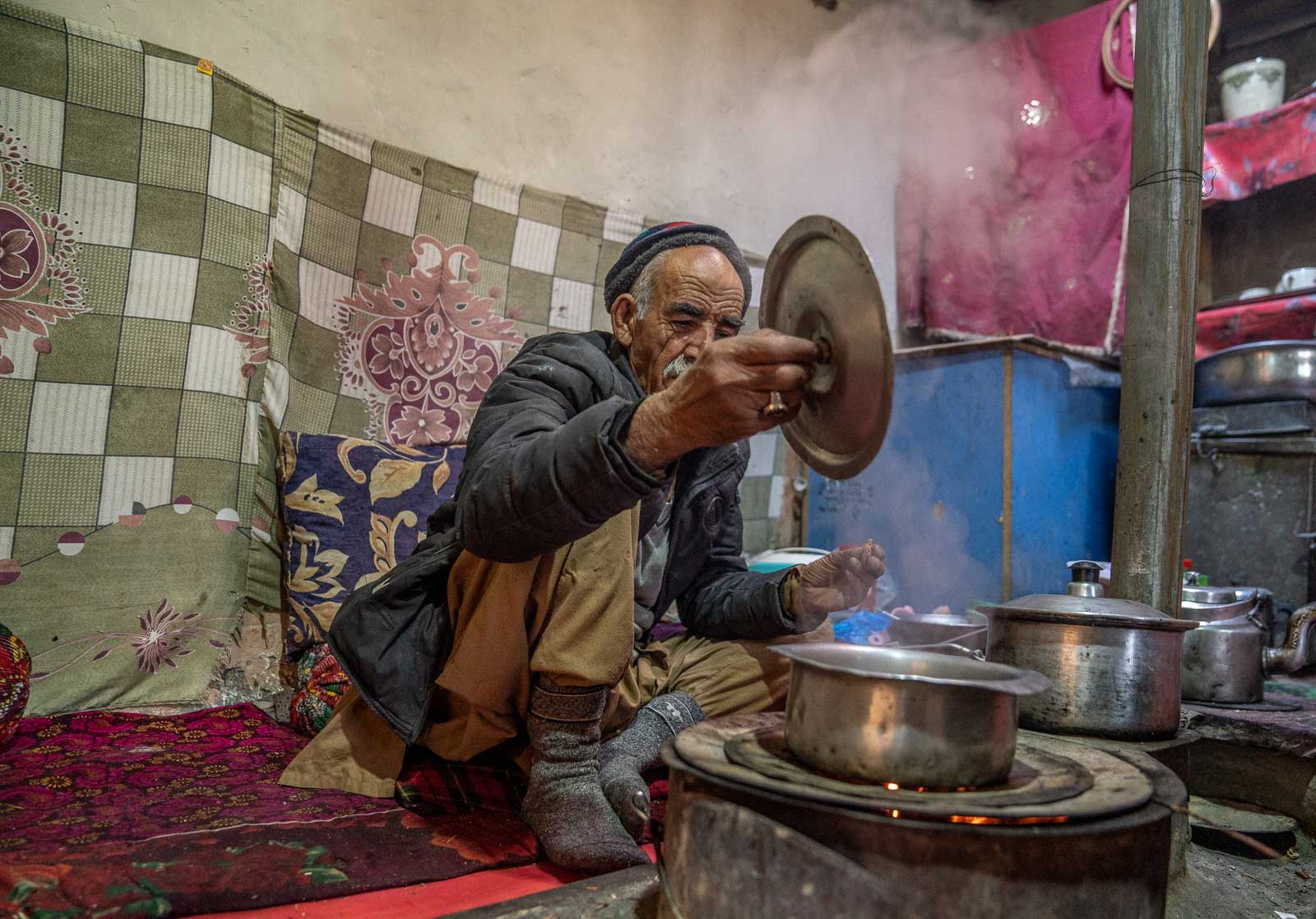 man boiling chai in pakistan