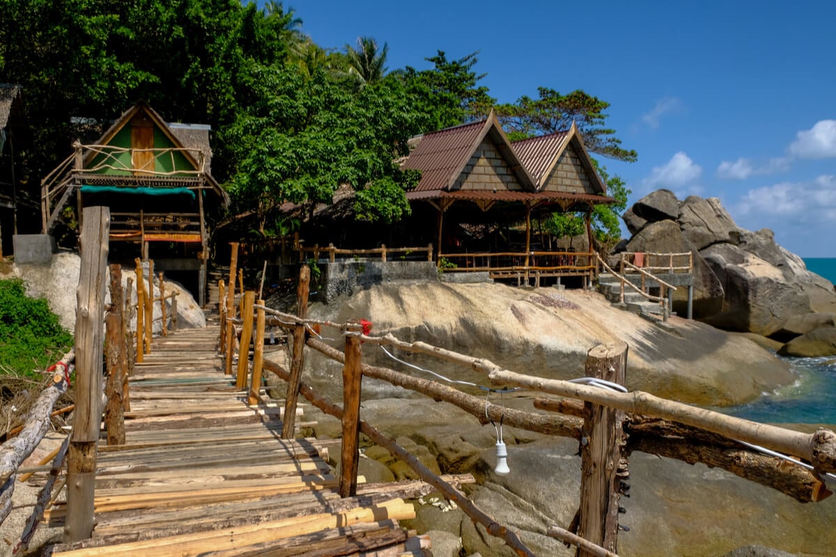 wooden huts and walkway leading to eden garden party koh phangan