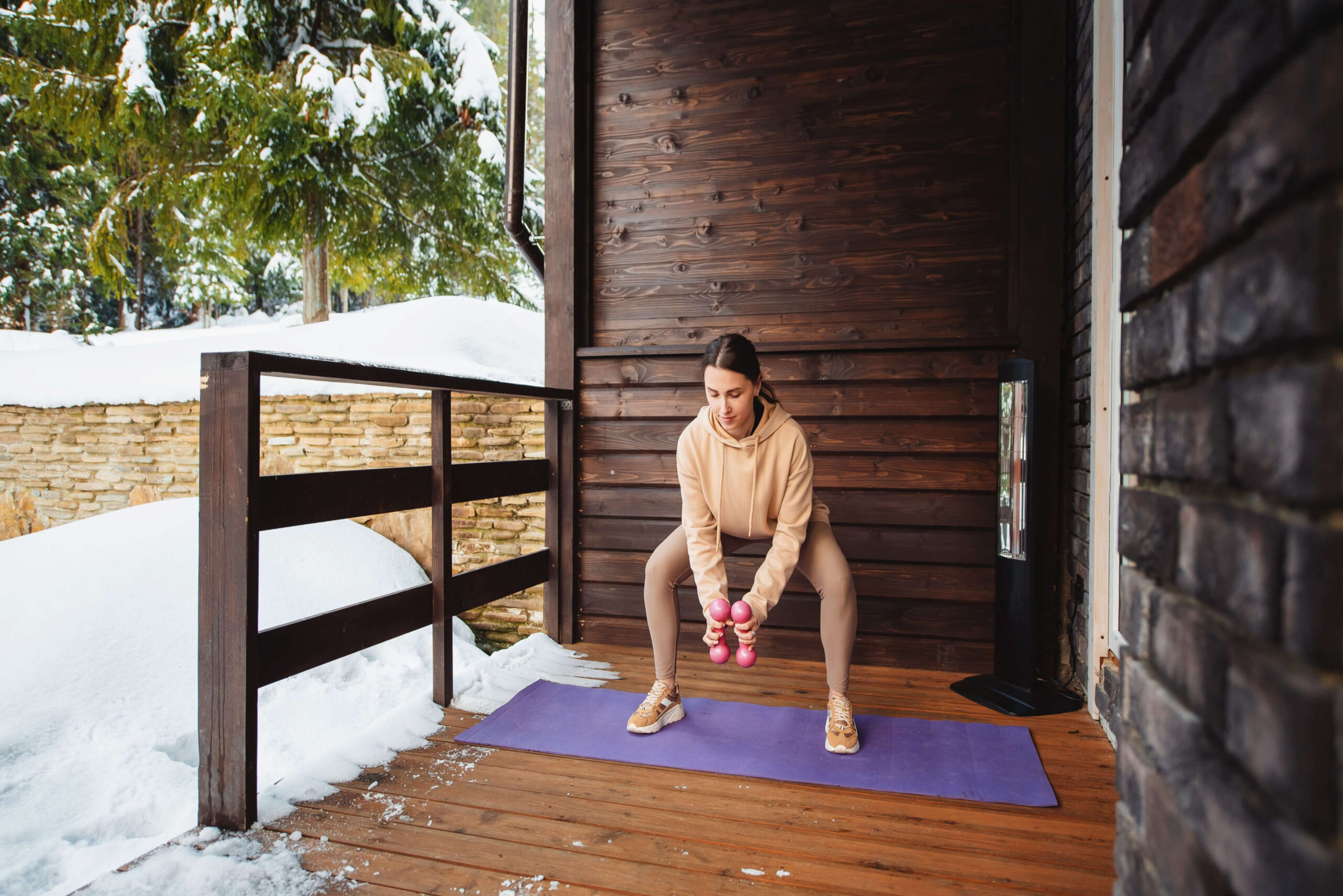 girl doing wall sits near snow