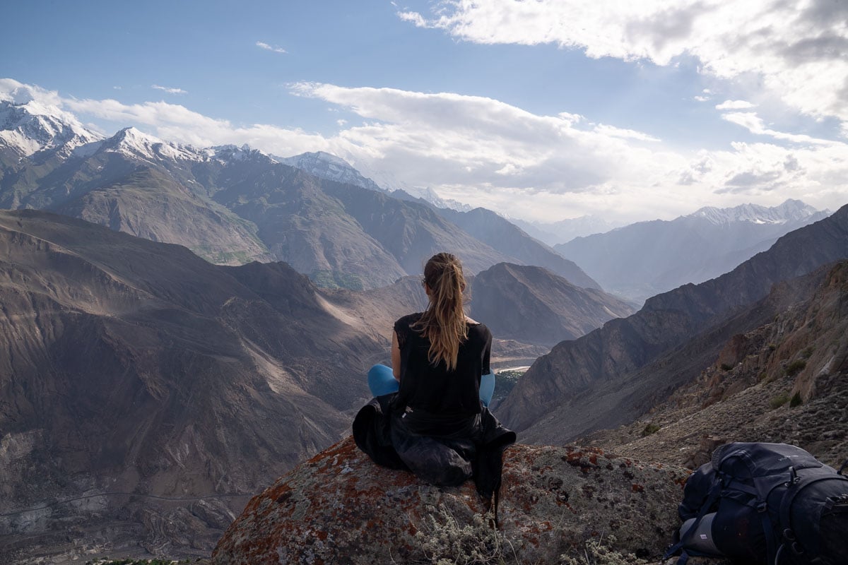 girl sitting on a rock mountain view in pakistan
