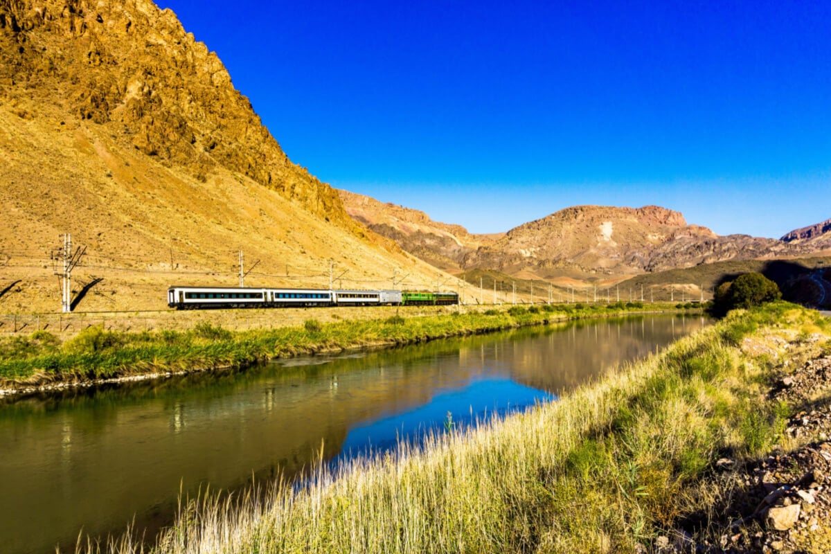 train traveling in dry marshland area of iran
