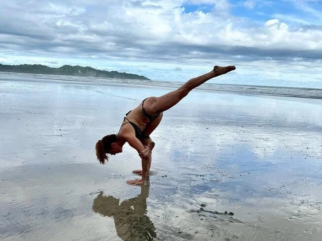 A girl doing Yoga at the beach 