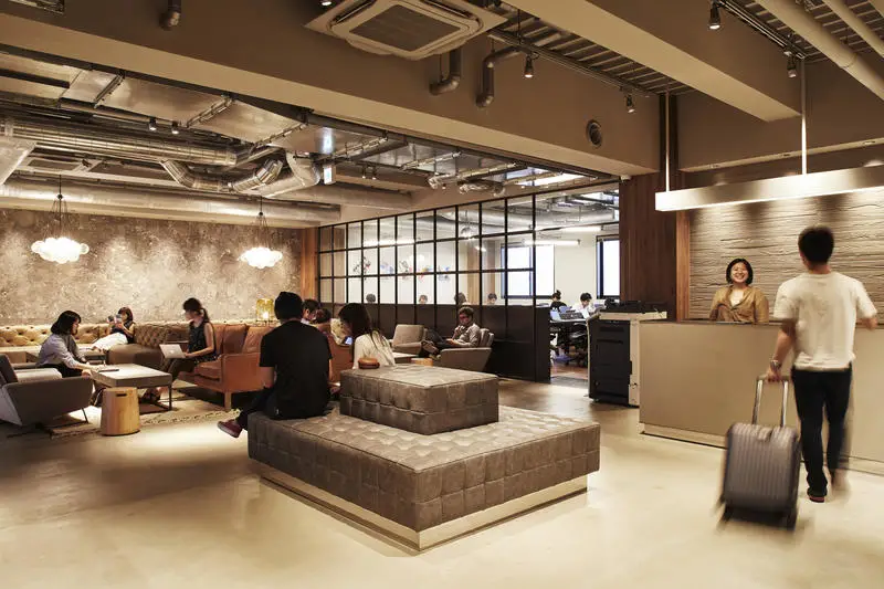 The Millennials - Best Hostel for Digital Nomads in Kyoto modern reception area with chic couches and reception desk