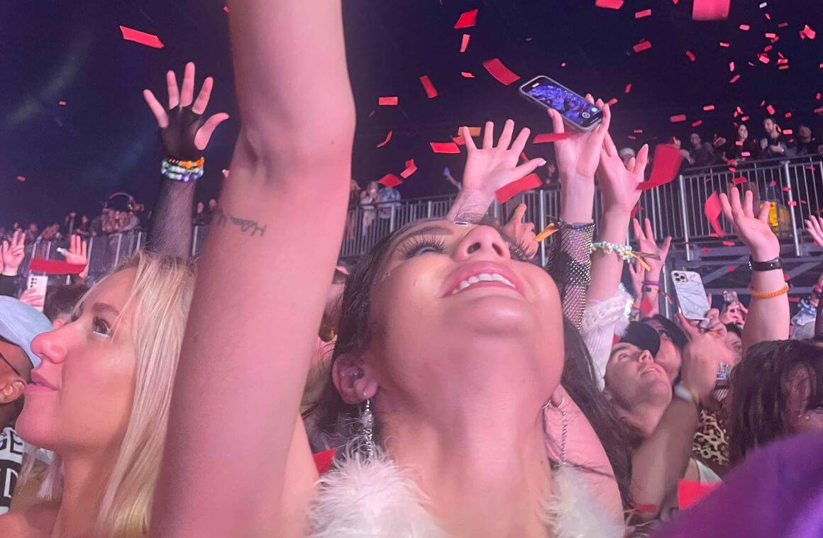 A picture taken in the crowd during an electronic daisy music festival.