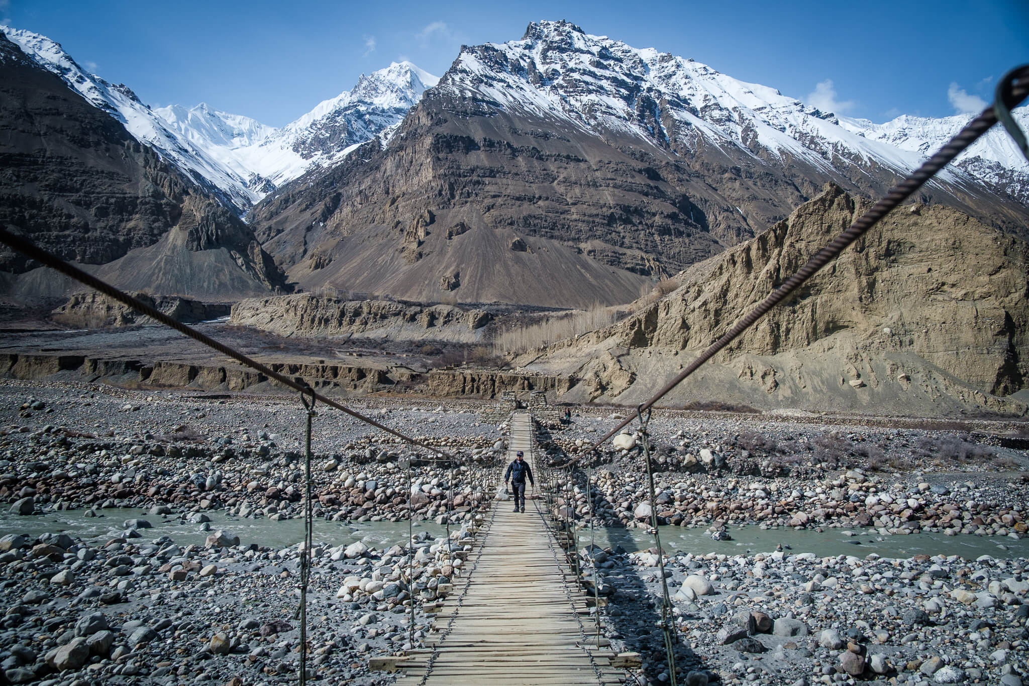 will walking on a bridge while backpacking pakistan