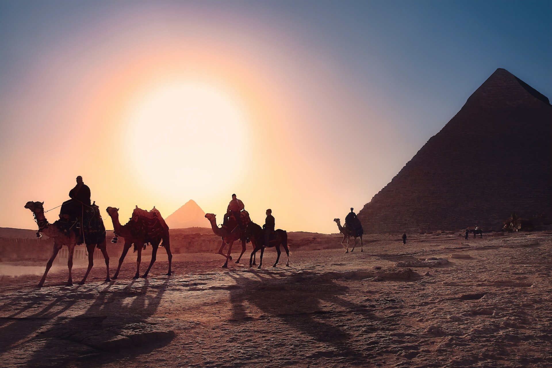 Egyptian Pyramids with Camel riders at night
