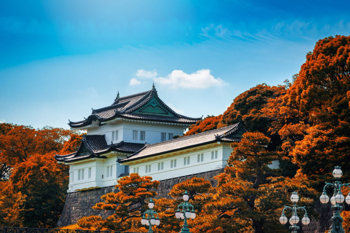 white japanese palace amidst orange foliage best places to visit in tokyo