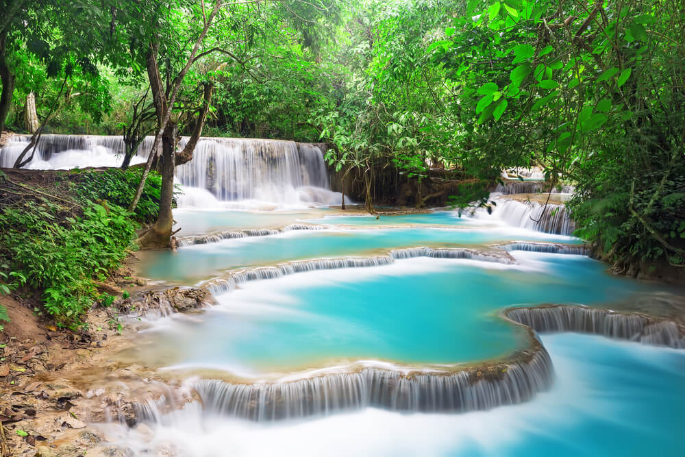 multi tiered bright blue waterfall pools in laos