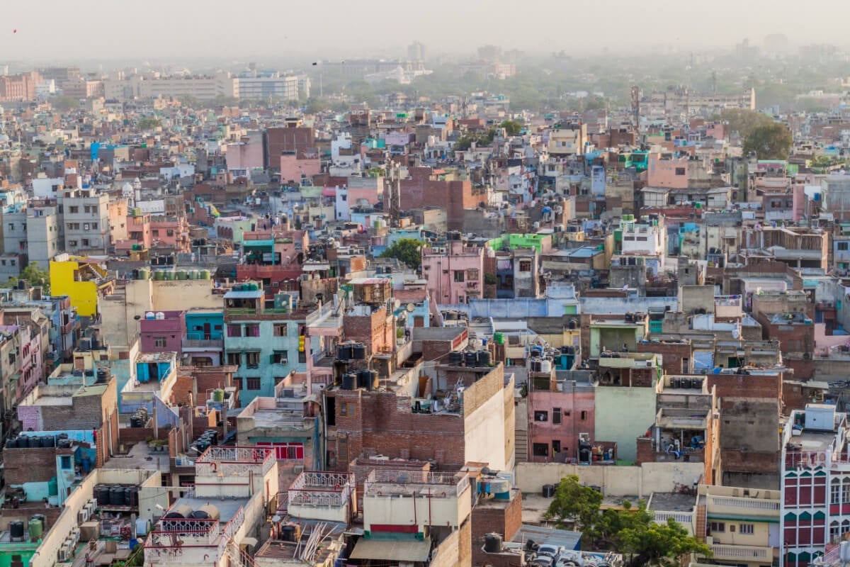 old city of new delhi as seen from above, lots of colorful buildings in hazy pollution