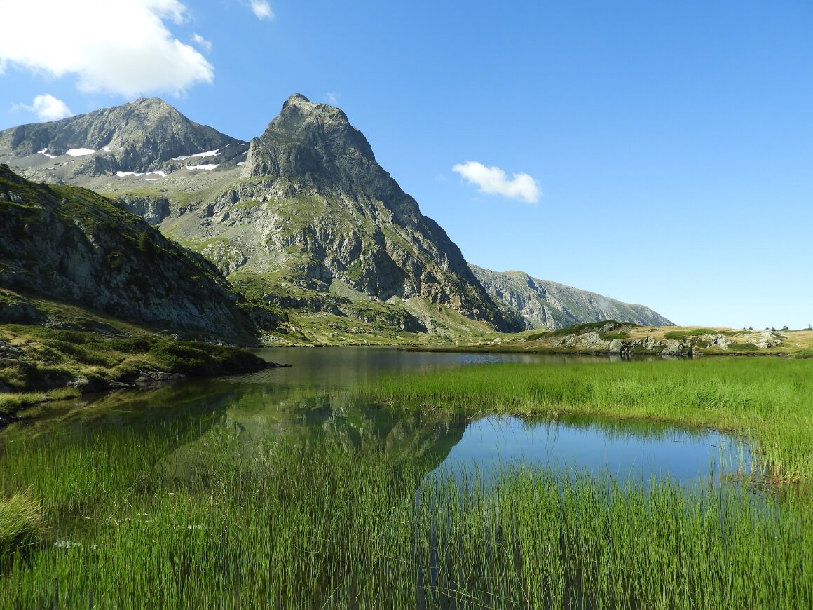 A landscape view of a late surrounded by mountains in Ecrins National Park, France