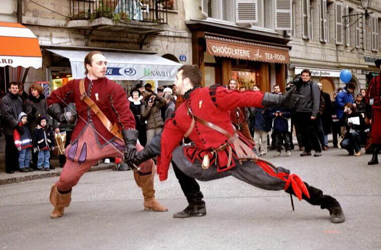 two men fighting with swords during Fete de L’Escalade in Switzerrland
