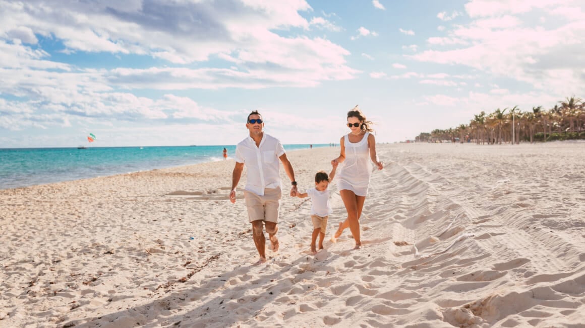 family walking down the beach