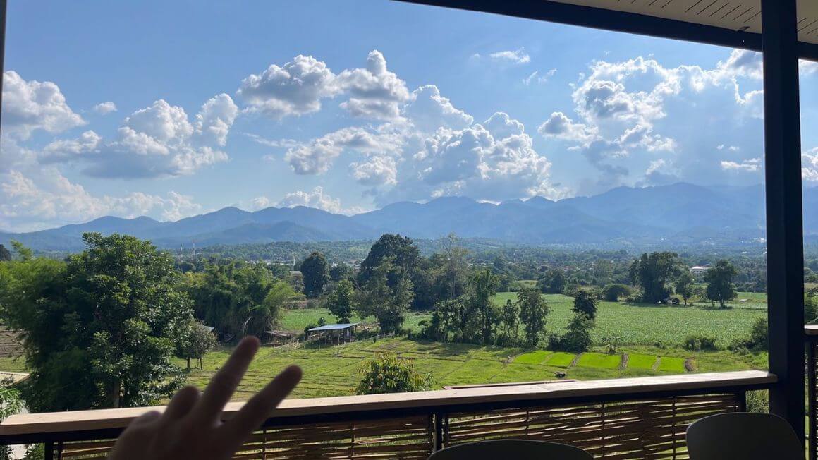 peace sign at a coffee shop overlooking the mountains in pai, thailand