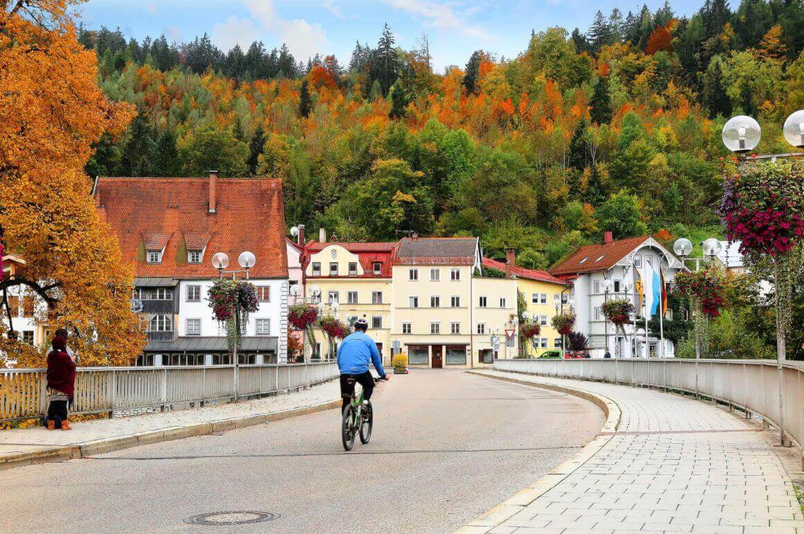 cyclist on a bridge in the Old Town of Fussen autumn