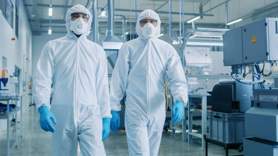 two scientists wearing sterile suits in laboratory