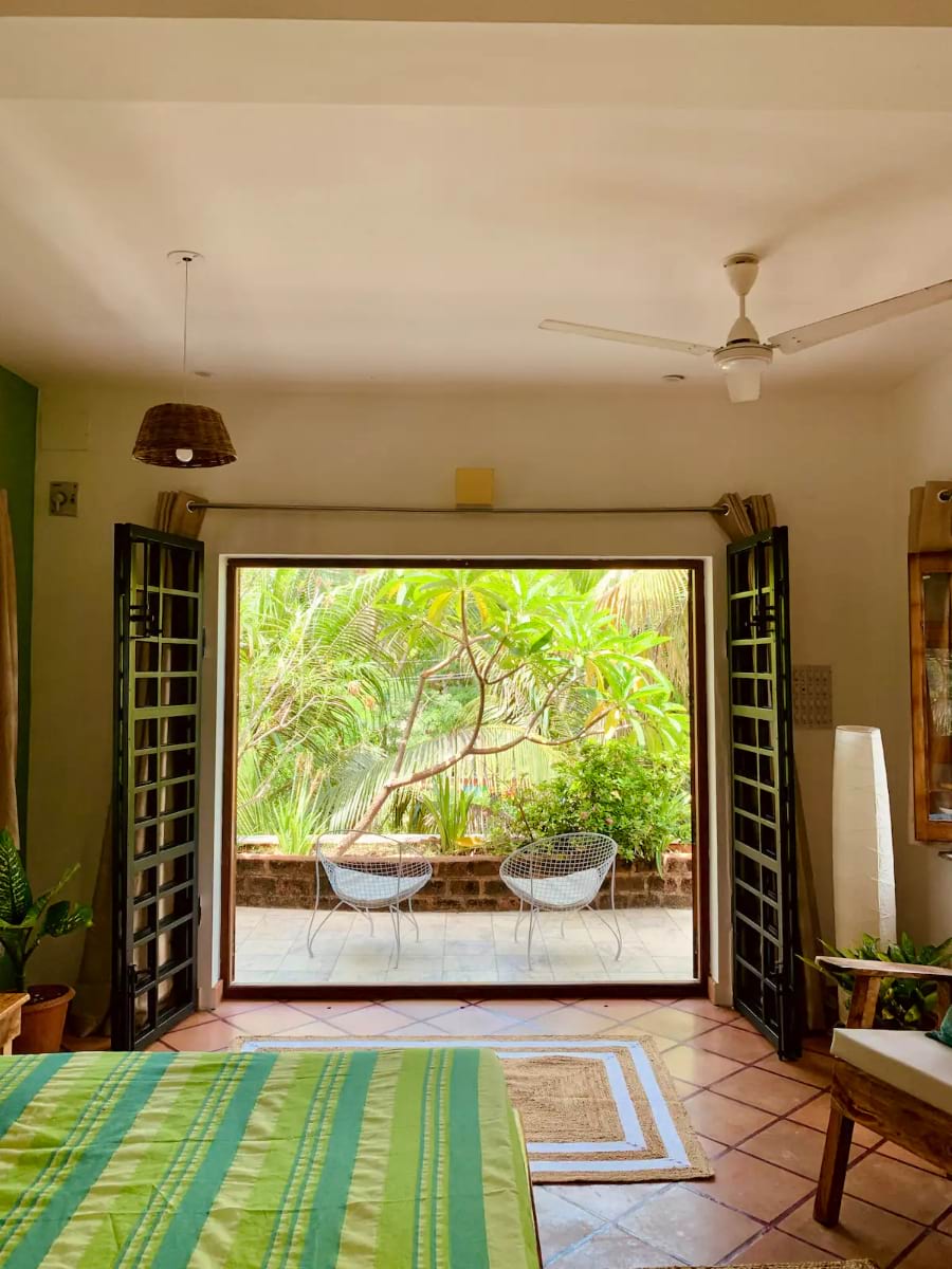 A bedroom interior with an open-door balcony in Pondicherry