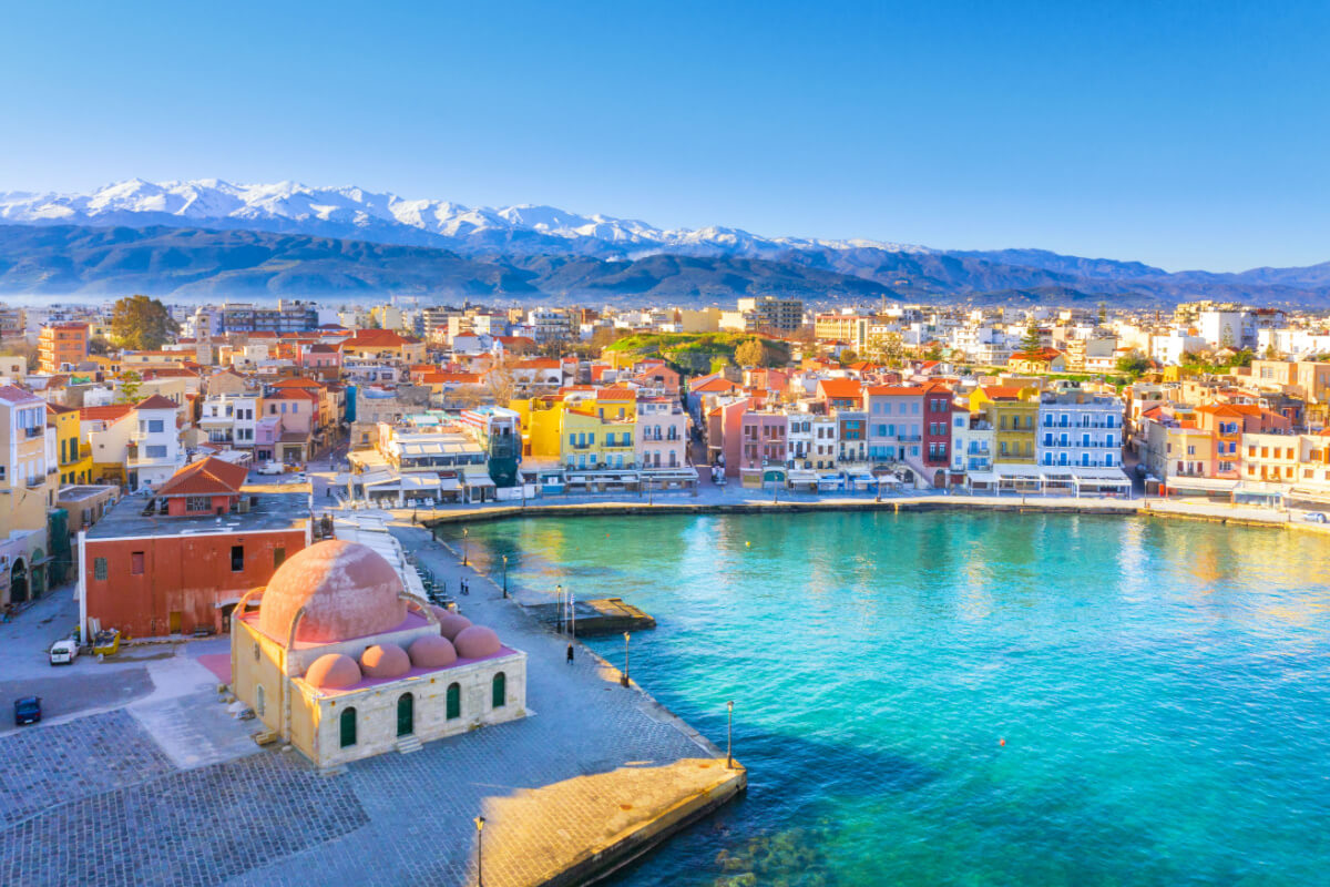 Chania old town and port landscape, with mountains rising in the distance