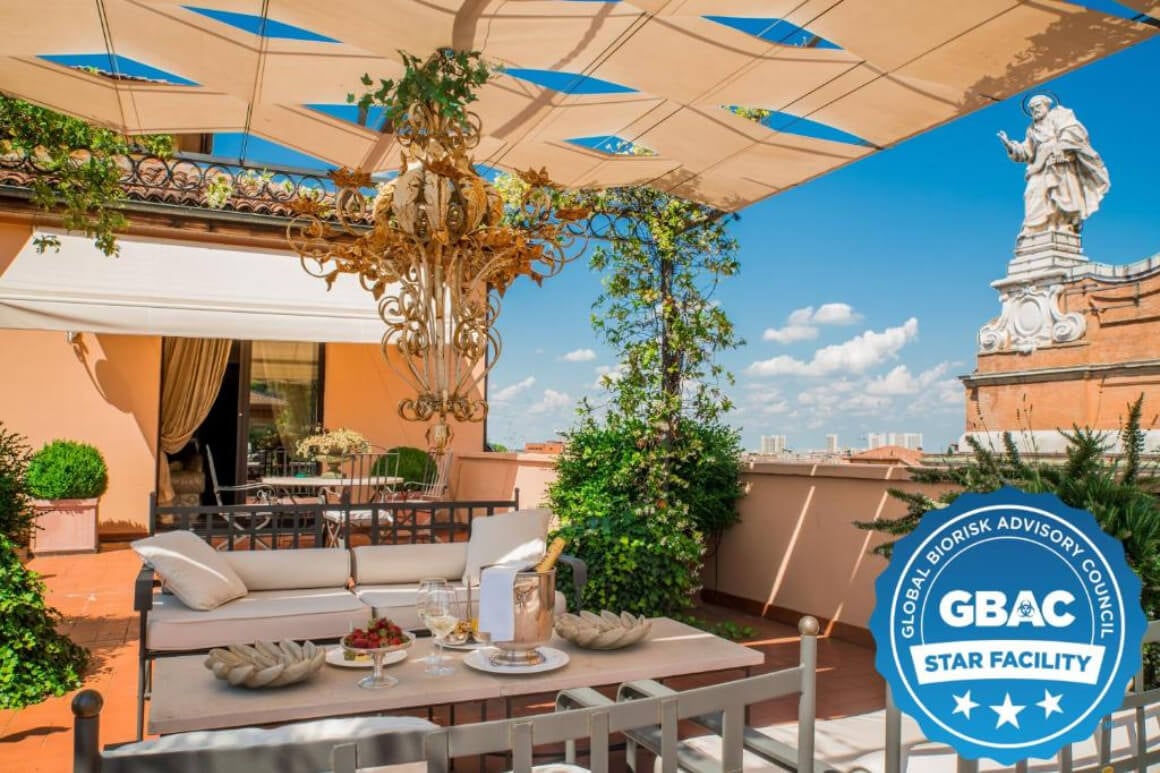 Shaded rooftop terrace with lush plants at teh Grand Hotel Majestic gia' Baglioni