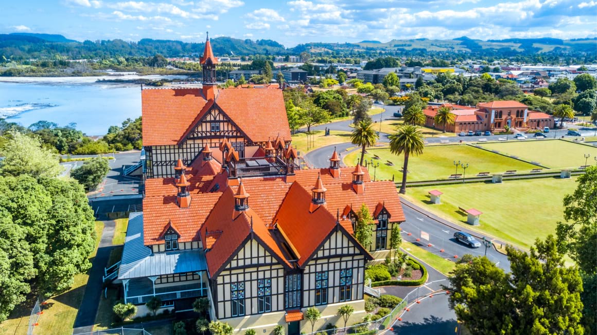 Rotorua Museum with lake and hill