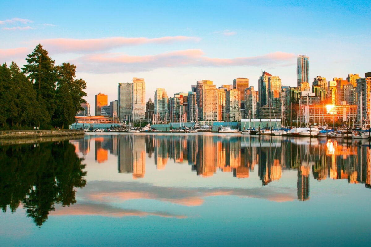 The stunning Vancouver cityscape rises over the lake.