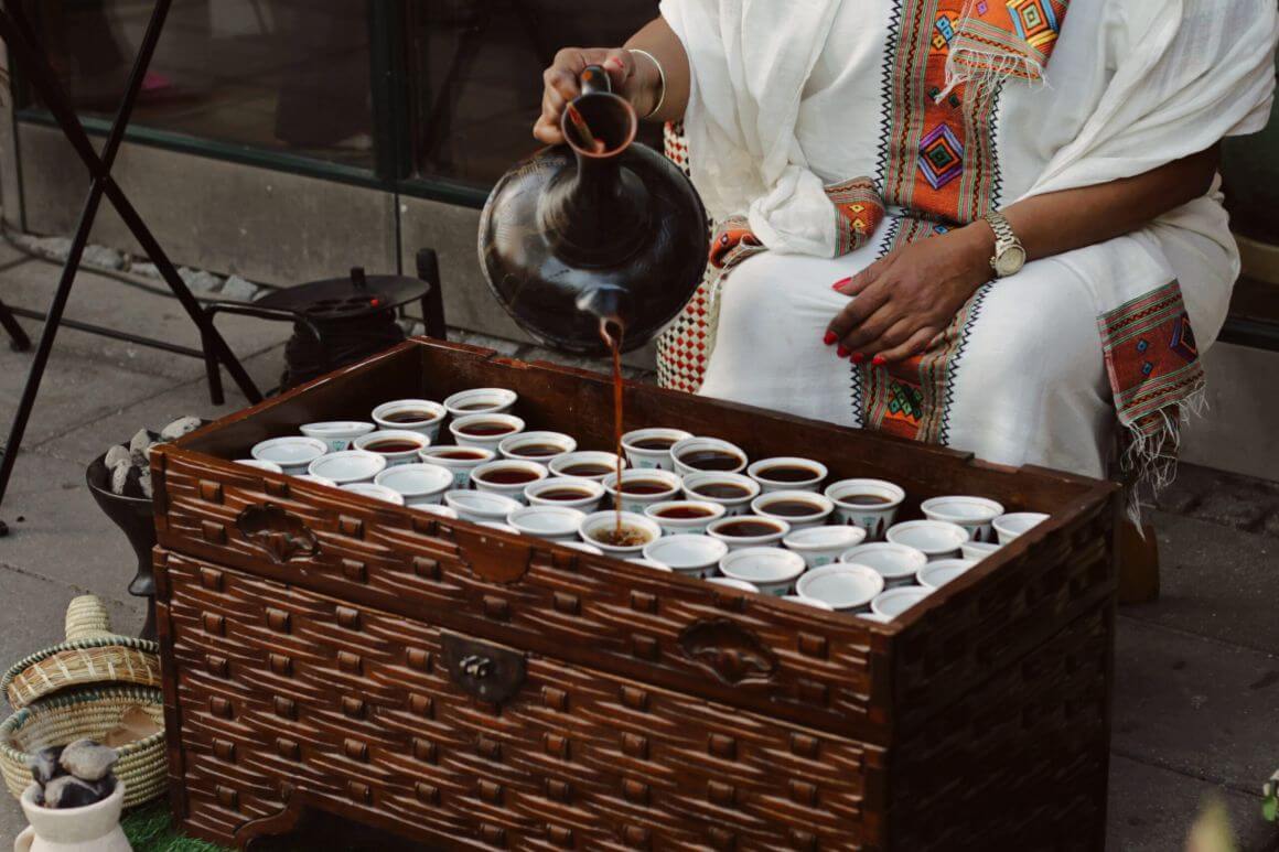 local pouring coffee on small cups