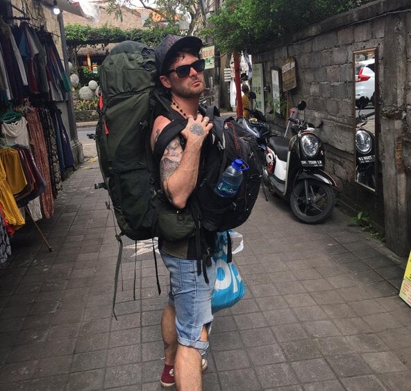 Aiden in Bali carrying 2 osprey 