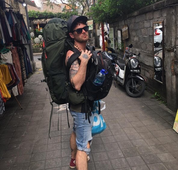 Aiden in Bali carrying 2 osprey