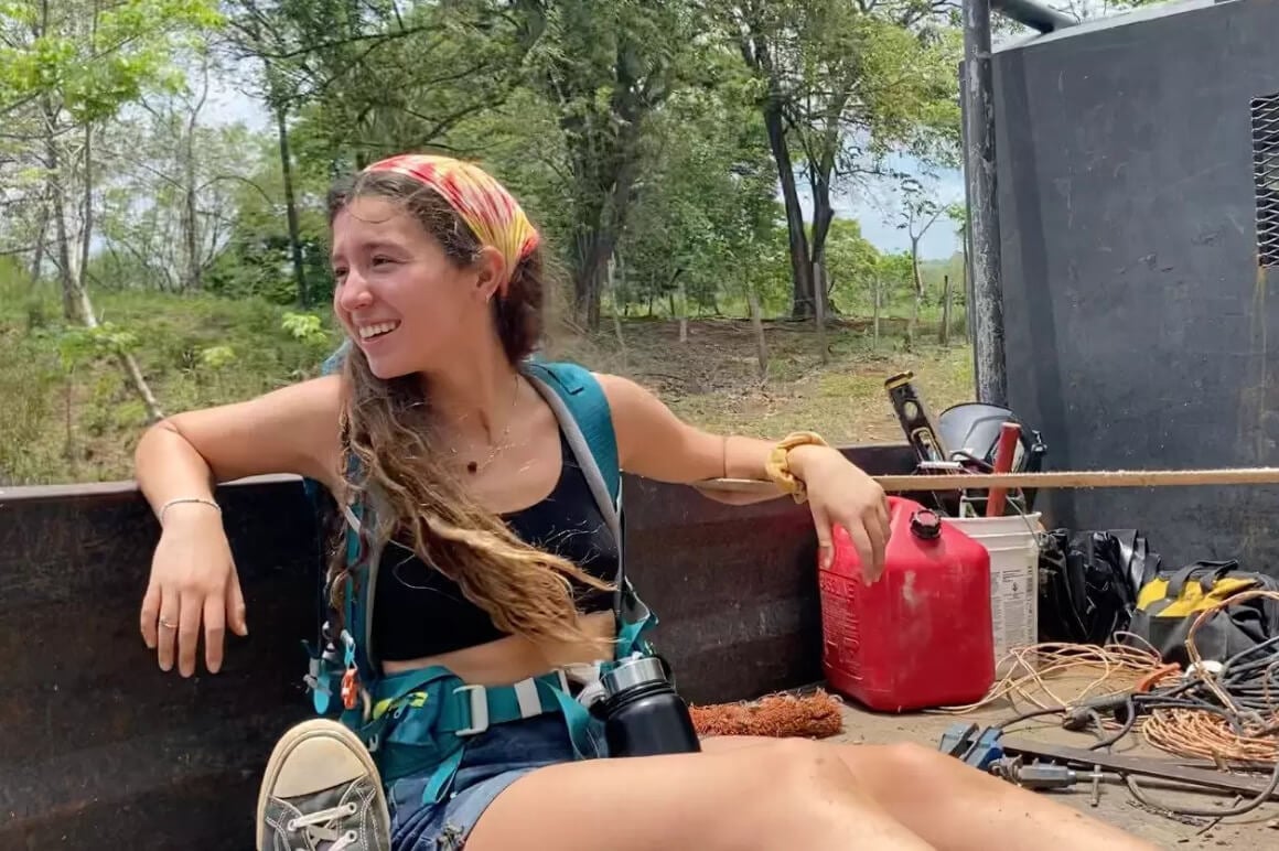 amanda hitchhiking in the back of a truck 