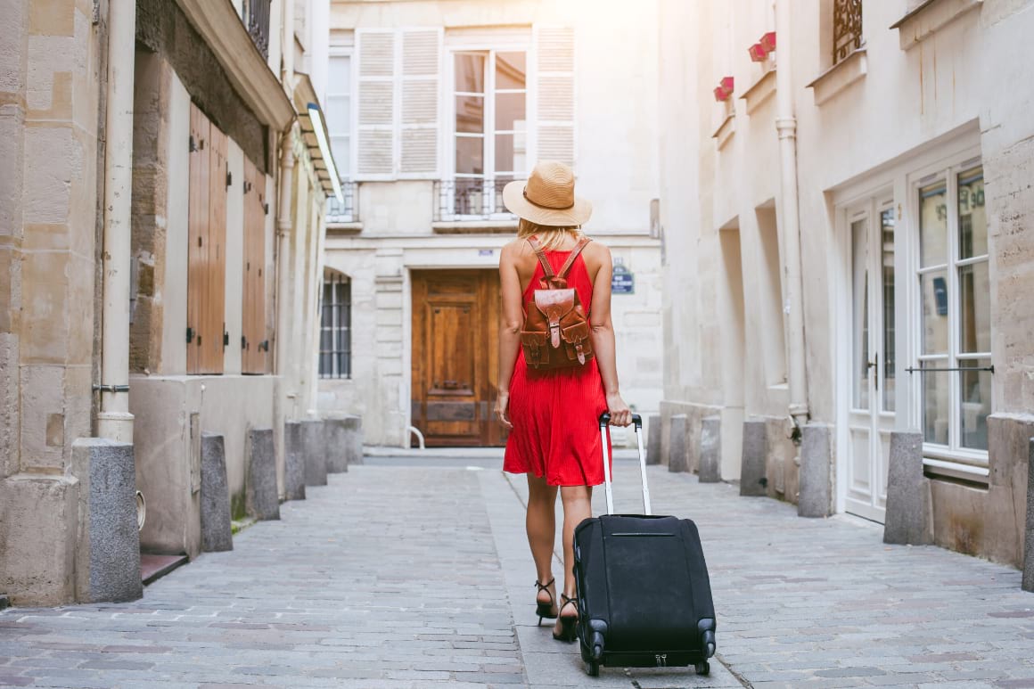 europe woman tourist walking with suitcase
