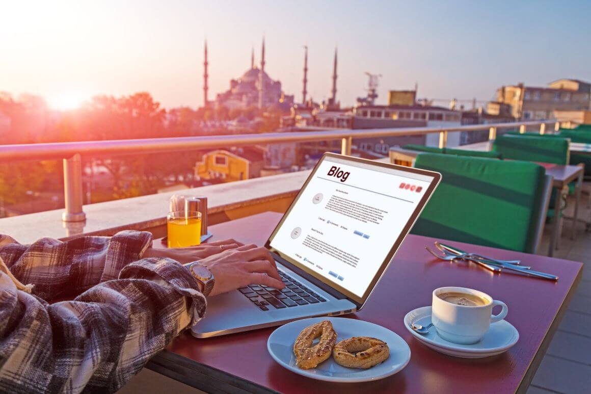 digital nomad working at cafe with breakfast